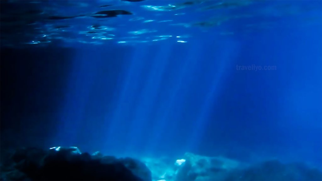 Underwater sunlight rays inside the Blue Cave Tanna