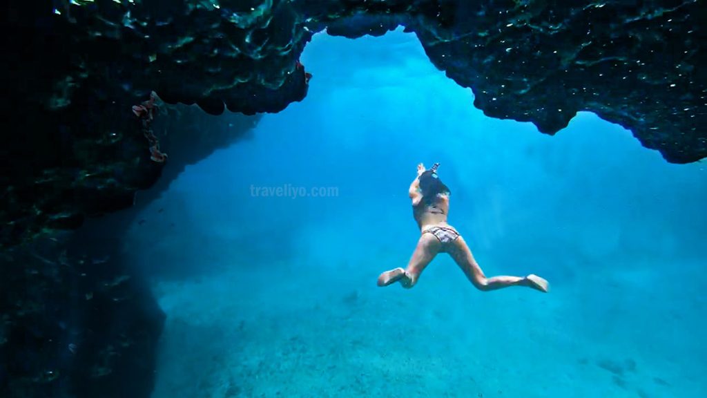 Diver exploring the glowing waters of Blue Cave Tanna