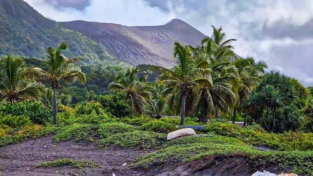 Volcanic black sand beach on Tanna Island with Mount Yasur in the background