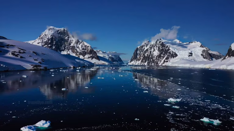 Antarctica Lemaire Channel narrow passage between towering icy mountains.