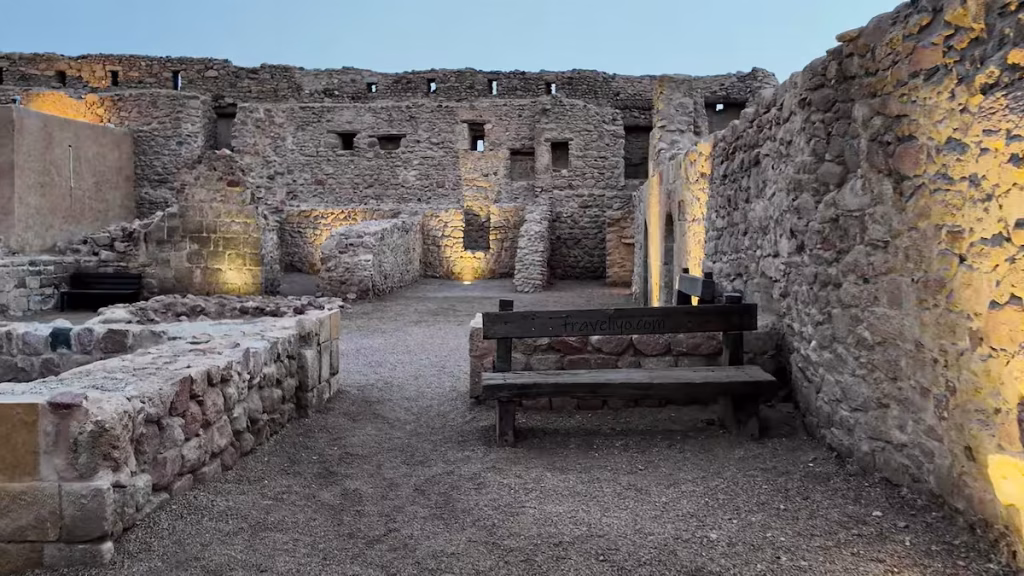 Ancient stone walls, a wooden bench, and ruined inner chambers inside the historic Aqaba Castle.