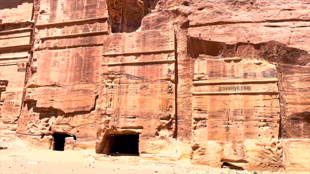 Close-up of square rock-cut block tombs with distinct Nabataean architectural details in Petra.