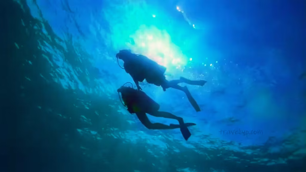Lakshitha and Tania scuba diving together in the clear blue waters of the Red Sea in Aqaba.