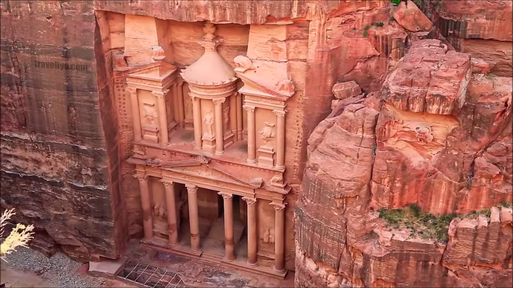 Aerial view of The Treasury, Al-Khazneh, carved into the rose-red sandstone cliff in Petra.