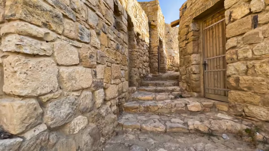Narrow stone-paved streets and rustic houses inside historic Dana Village.