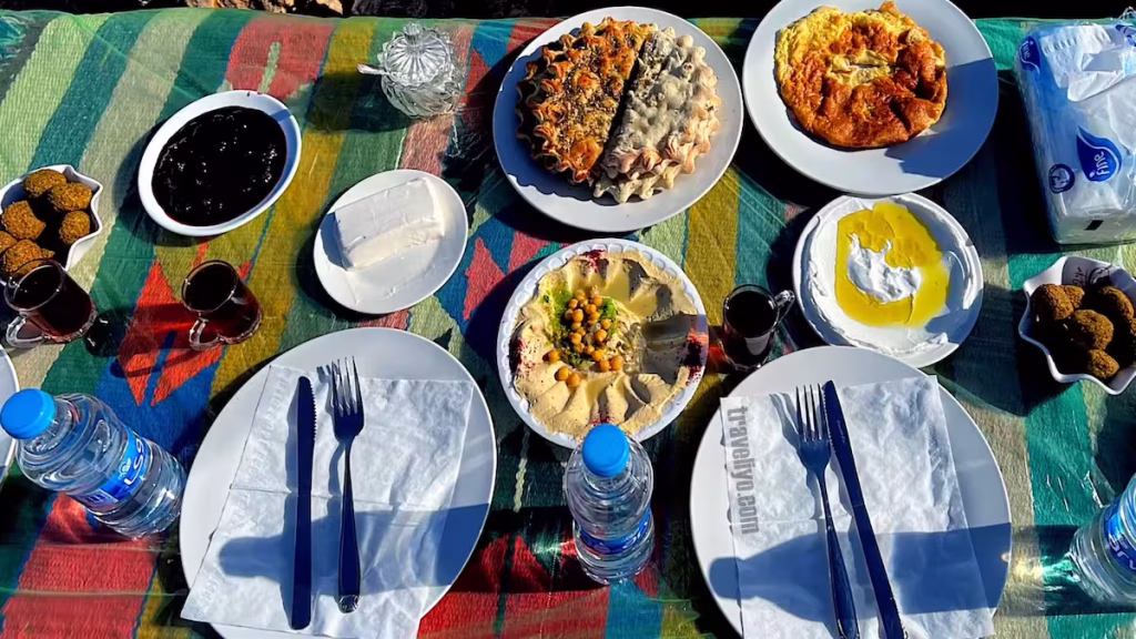 A spread of Jordanian breakfast items including Labneh, olives, and fresh bread.