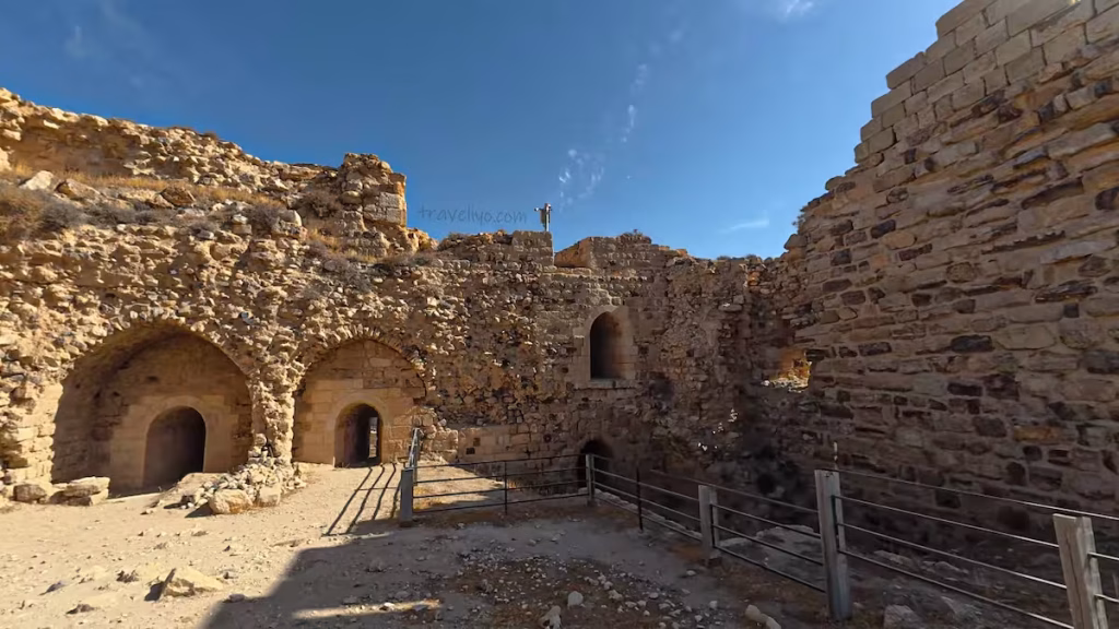 Arched stone doorways and ruined walls within an inner courtyard of Karak Castle.