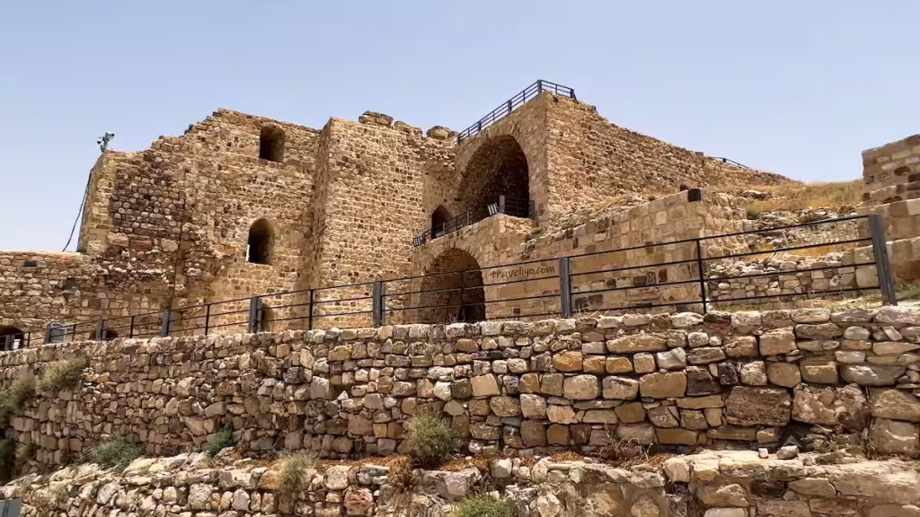 Multi-level stone structures and arched ruins of the upper citadel at the Karak Jordan castle.