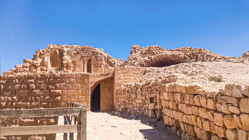 An open pathway surrounded by historic stone ruins at Shobak Castle in Jordan.