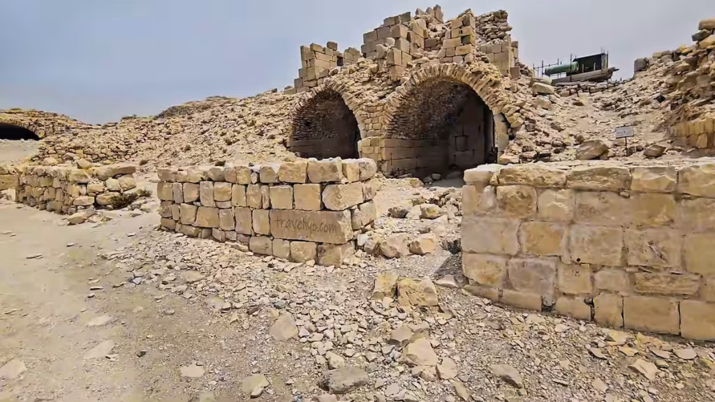 Stone ruins with visible arched entrances at Shobak Castle in Jordan.