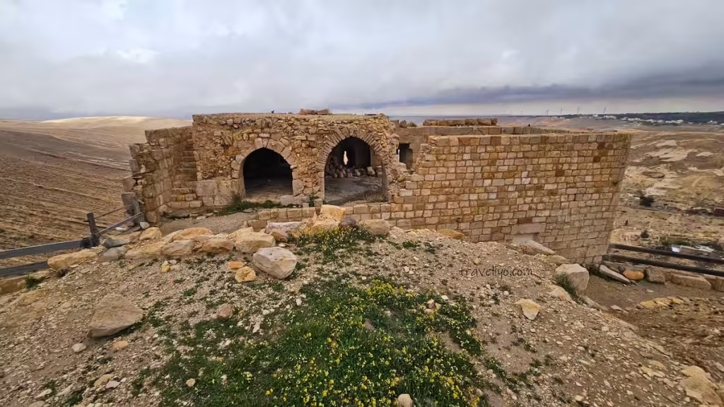 Ruined stone walls and ancient stone structures inside the Shobak Castle in Jordan grounds.