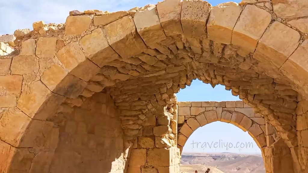 A beautiful stone arch looking through to another arch against a blue sky at Shobak Castle in Jordan.