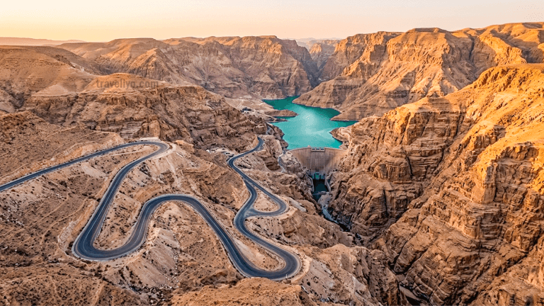 Aerial view of the winding Route 35 King's Highway cutting through the Jordan grand canyon with the reservoir in the background.