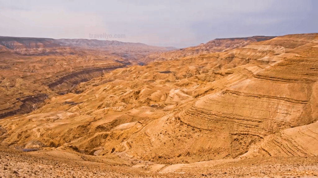 Layered geological rock formations and canyon walls on the slopes of the grand canyon of jordan.