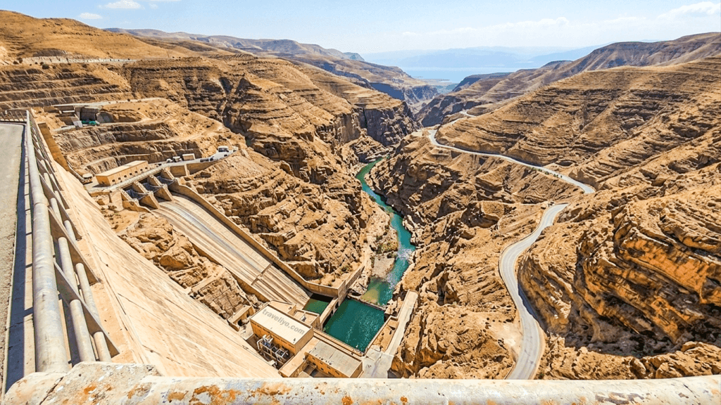 Looking down at the massive Mujib Dam structure nestled within the grand canyon jordan.