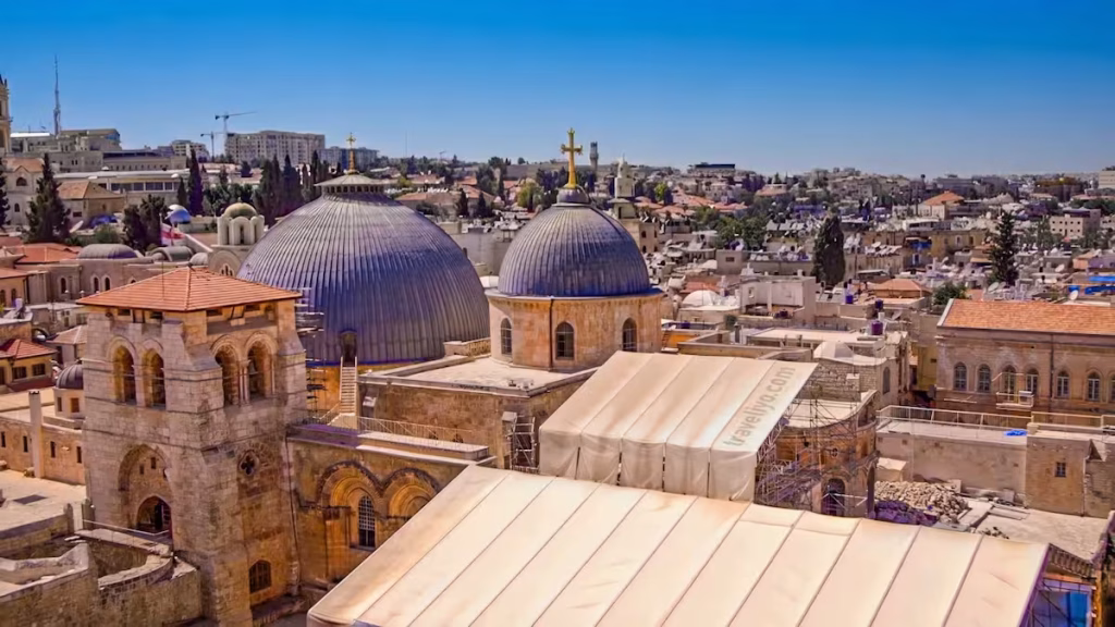 Panoramic view of the Madaba skyline featuring the blue domes of the Shrine of the Beheading of Saint John the Baptist.