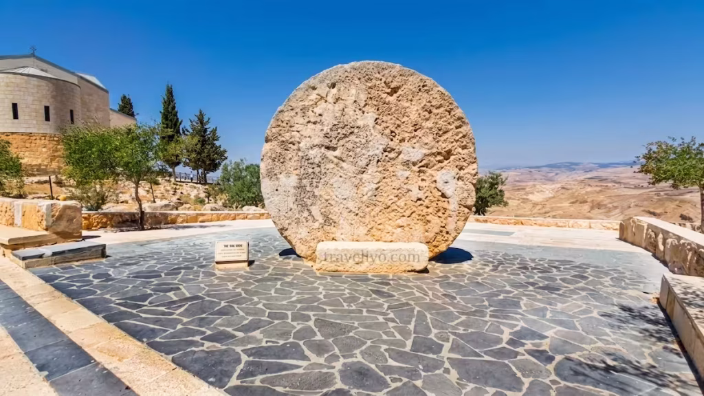 The historic Abu Badd rolling stone monument used as a monastery door at Mount Nebo Jordan.