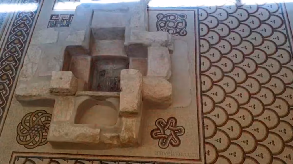 Intricate geometric Byzantine mosaic tilework surrounding the ancient baptistery at Mount Nebo Jordan.