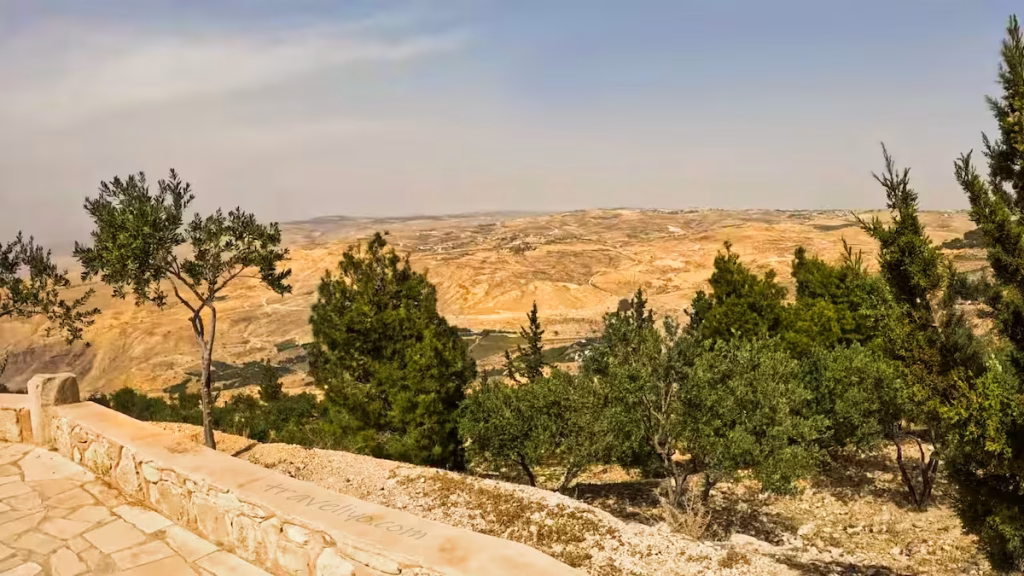 A wide landscape view of the rugged Jordan Valley terrain from Mount Nebo.