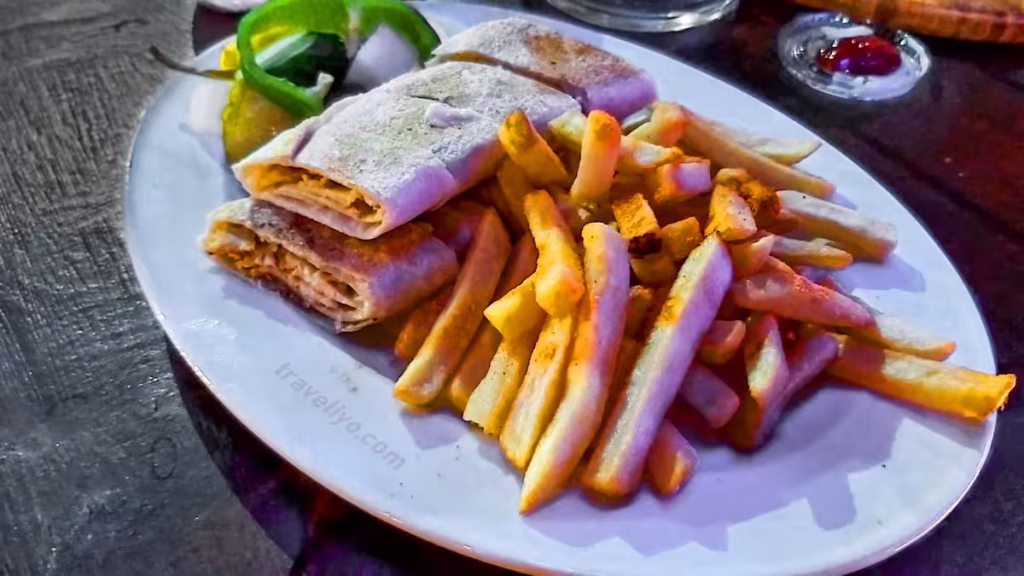 A delicious plate of traditional Arabic shawarma with french fries enjoyed in Madaba, Jordan.