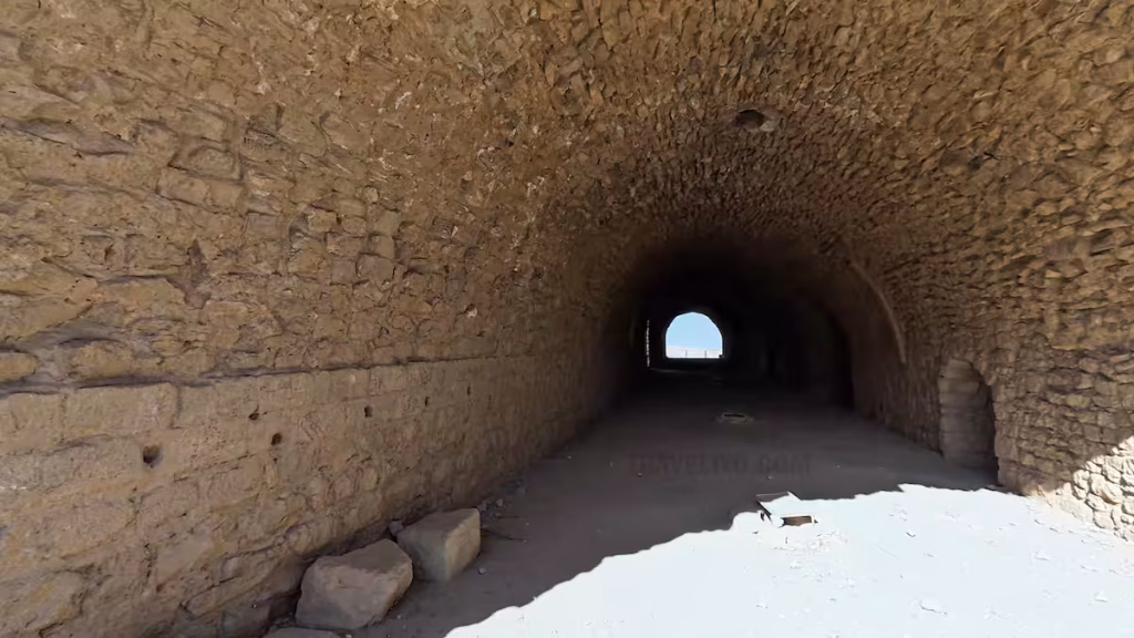 Dark stone tunnel corridor inside Al Karak Castle in Jordan.