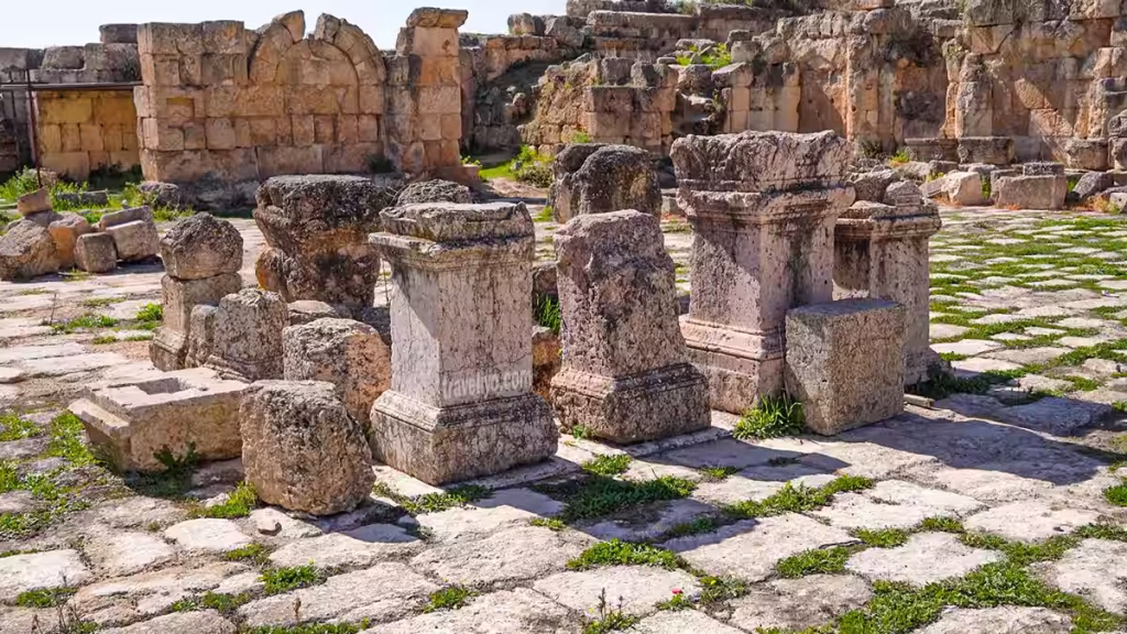Stone pedestals and courtyard ruins of the ancient Macellum Roman market in Jerash Jordan
