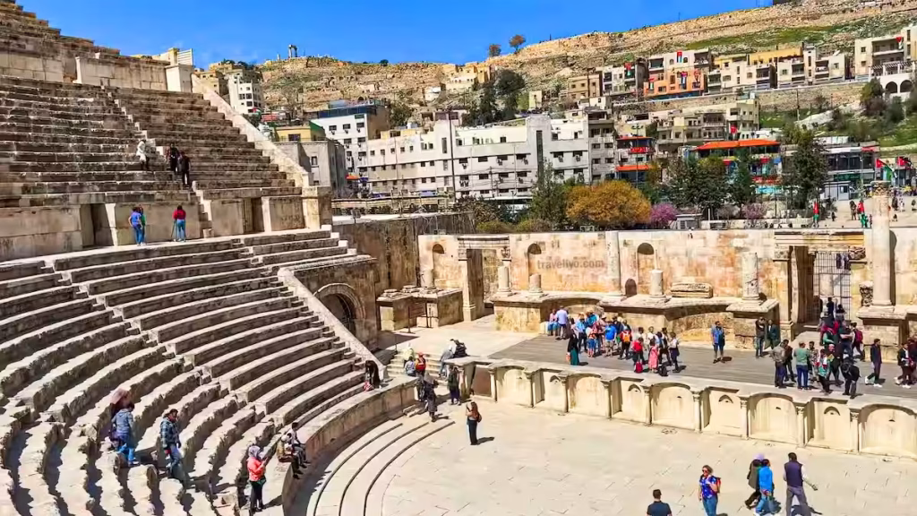 Tourists exploring the historic Roman Theater in Amman during Jordan's peak spring travel season.