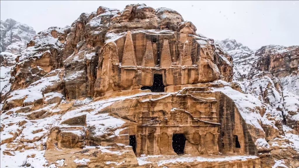 Ancient Obelisk Tomb in Petra covered in fresh white snow during winter season in Jordan.